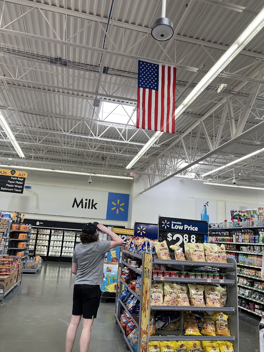 Tyler saluting the American flag at Walmart