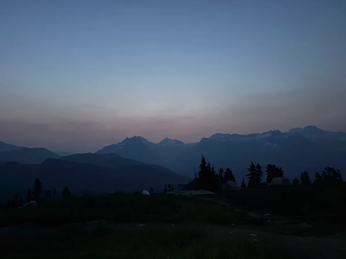 Mountain silhouettes beneath a softly colored early morning sky