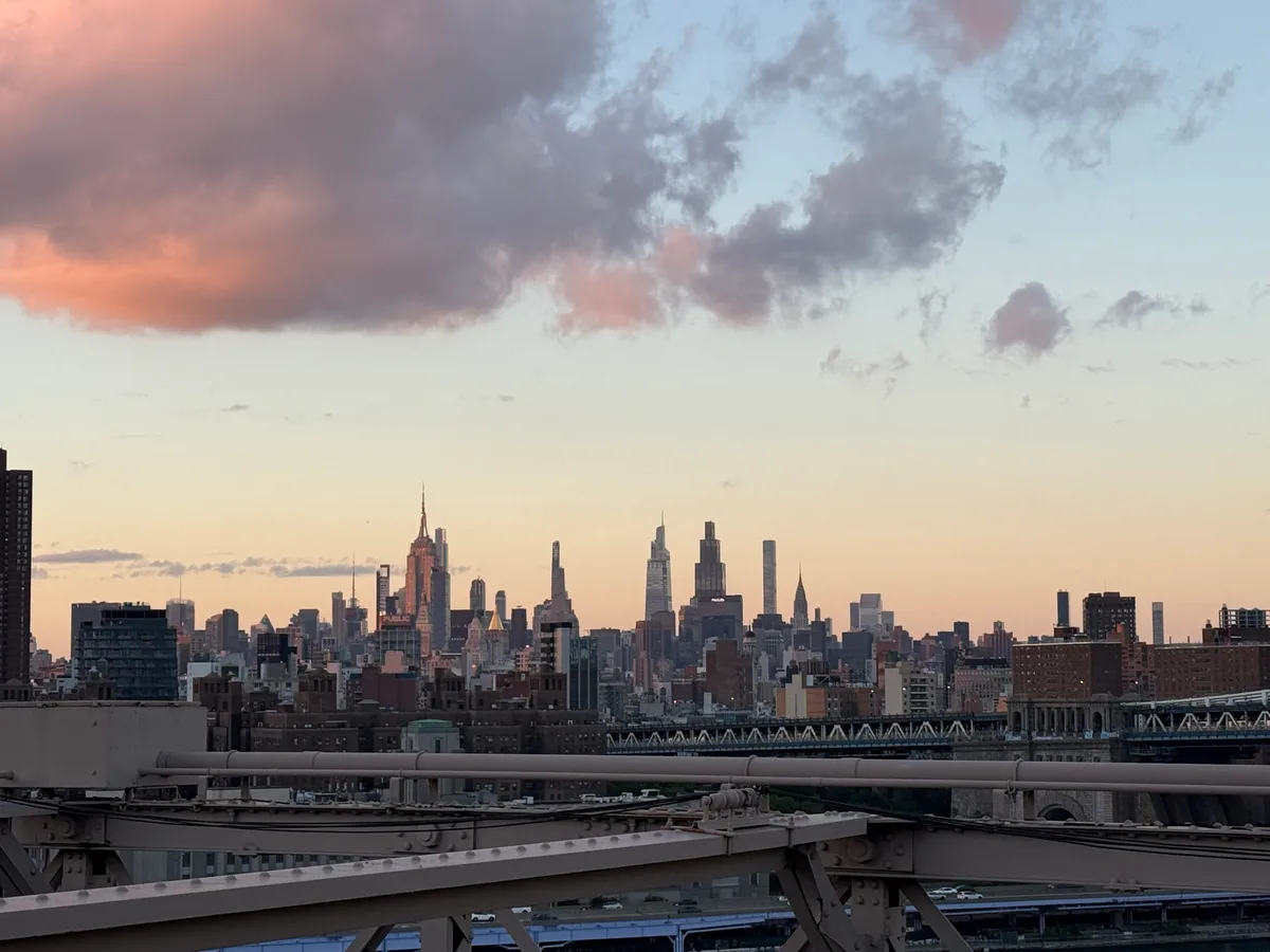 The Manhattan skyline beneath pink evening clouds