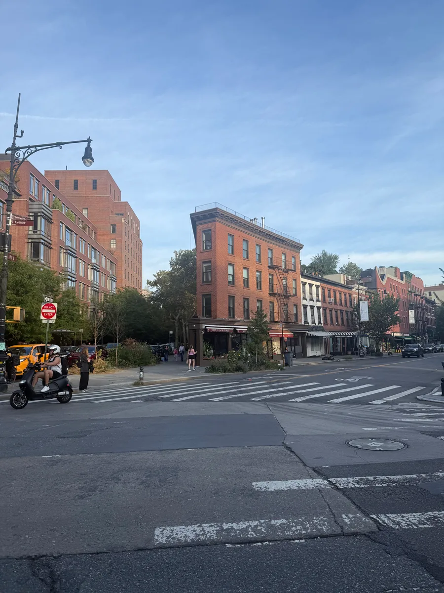 A crosswalk and red brick buildings at a city intersection