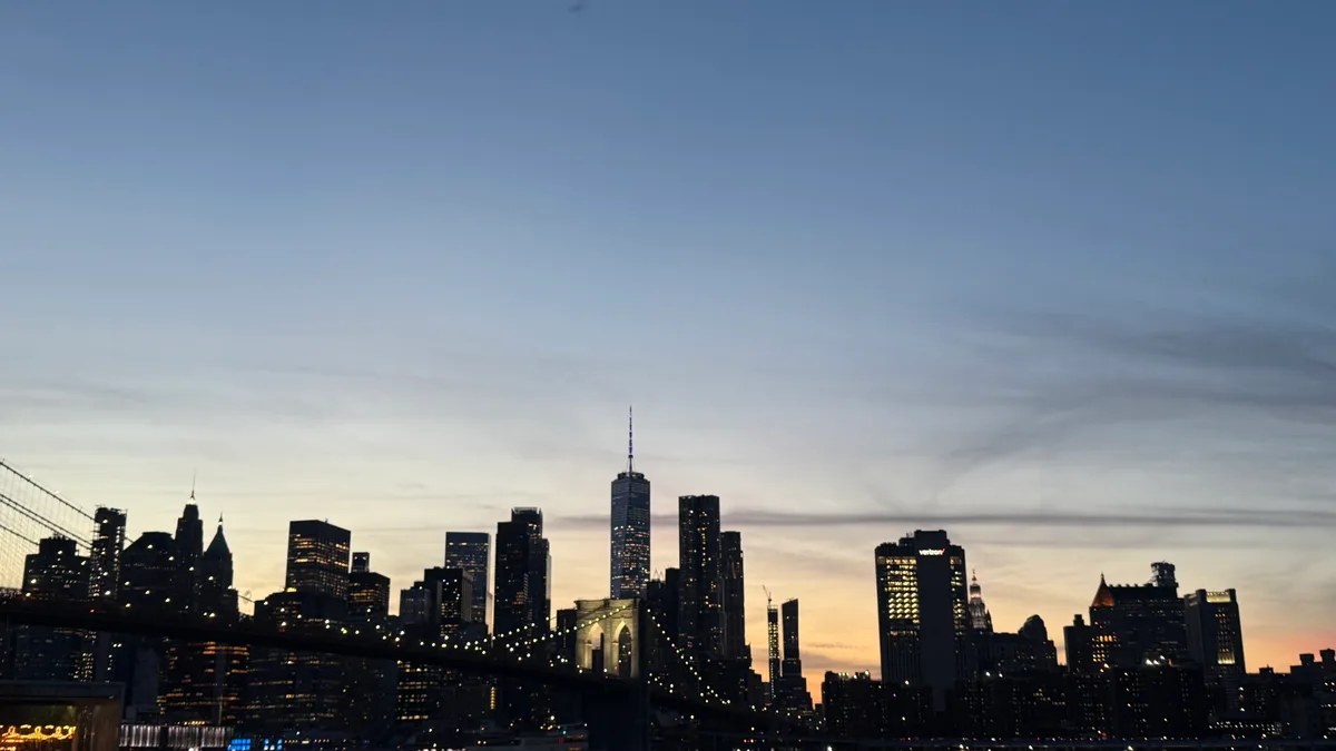 Manhattan and the Brooklyn Bridge beneath streaks of twilight clouds