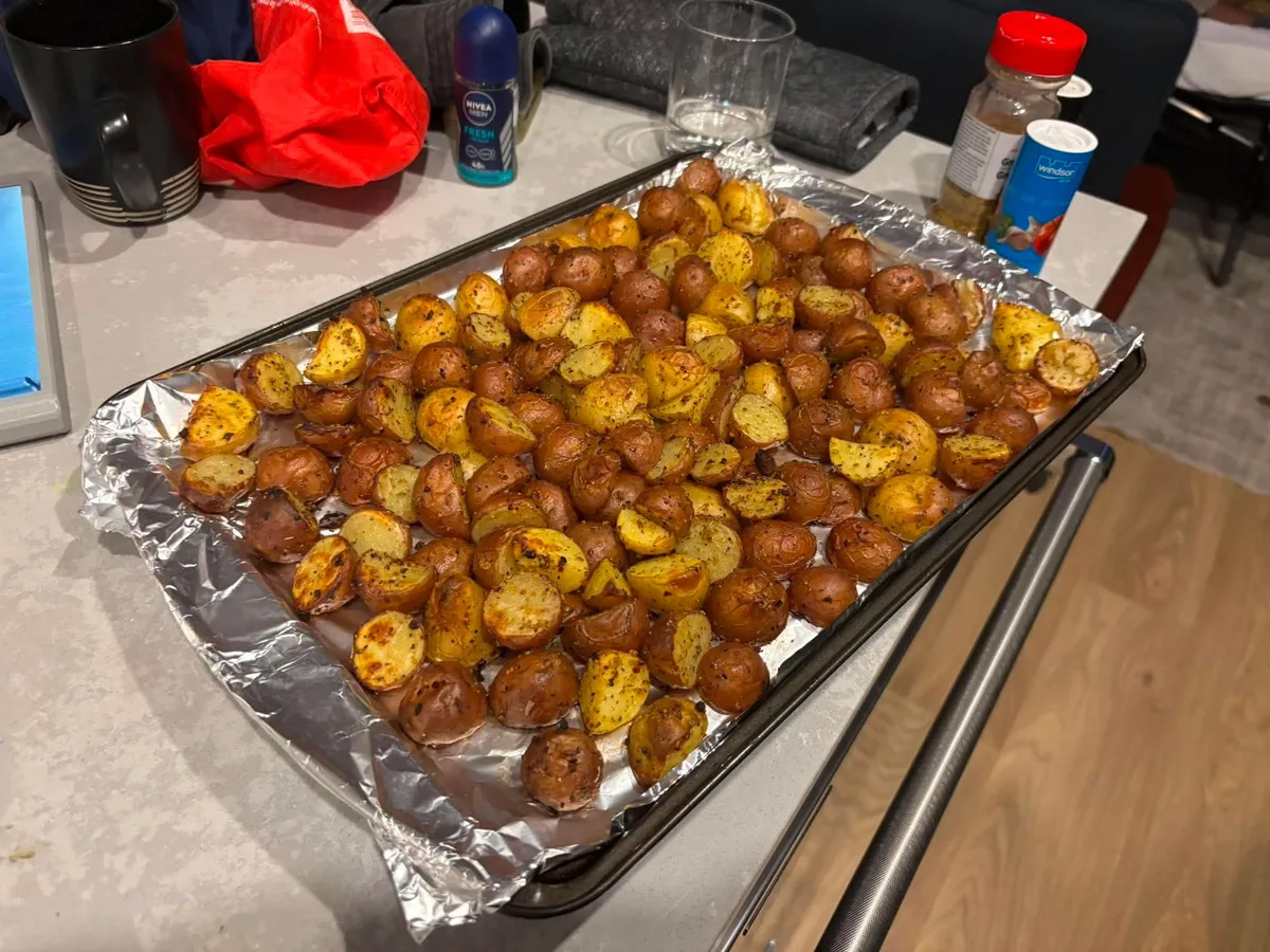 A baking tray filled with roasted potatoes